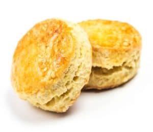 Freshly baked biscuits served with sweet jelly spread.