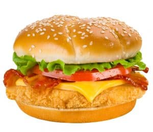 A crispy chicken sandwich with lettuce, tomato, cheese, and a sesame seed bun.