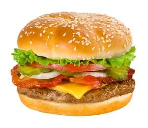A juicy hamburger with lettuce, tomato, cheese, and bacon in a sesame seed bun.