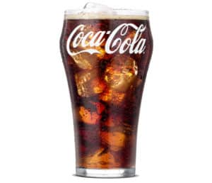 A fizzy and refreshing soft drink served over ice, featuring popular soda options like Coca-Cola.